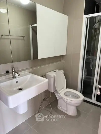 Modern bathroom with sleek fixtures and glass shower enclosure