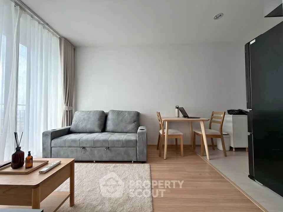 Modern living room with sleek furniture and natural light, perfect for urban living.