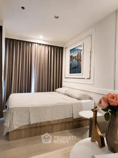 Elegant bedroom with modern decor and cozy ambiance, featuring a large bed and stylish curtains.