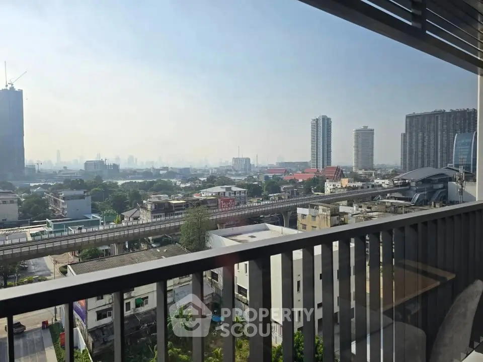 Stunning cityscape view from a modern balcony, showcasing urban skyline and vibrant surroundings.