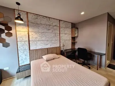 Modern bedroom with stylish decor and workspace, featuring a comfortable bed and sleek desk.