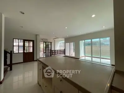 Spacious open-plan living area with large windows and modern design