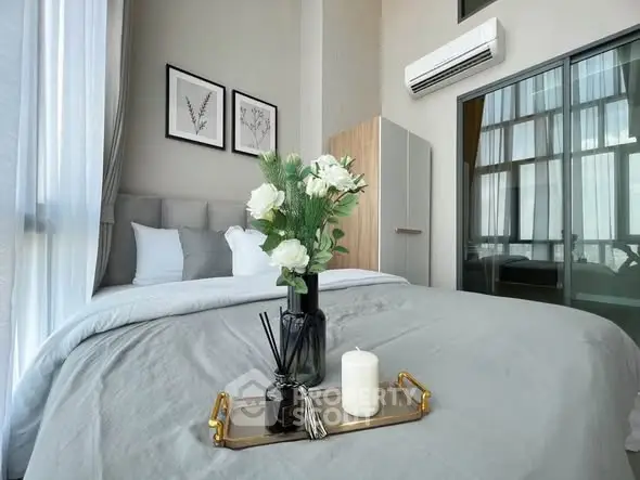 Modern bedroom with elegant decor and large windows for natural light.