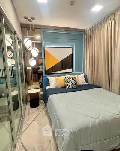 Modern bedroom with stylish decor and large mirrored wardrobe
