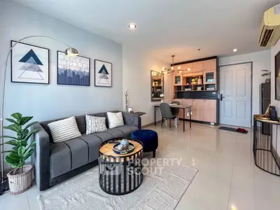 Modern living room with stylish decor and open kitchen layout in a cozy apartment.