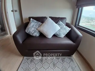 Cozy living room with stylish brown sofa and scenic window view