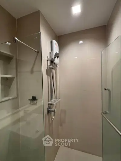 Modern bathroom with glass shower enclosure and sleek fixtures