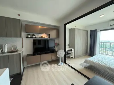 Modern studio apartment with open layout, featuring a cozy living area and bedroom with balcony view.