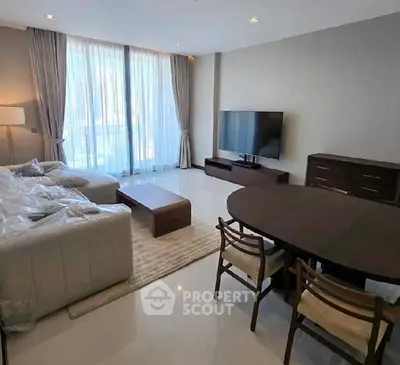 Spacious modern living room with large windows and elegant furniture