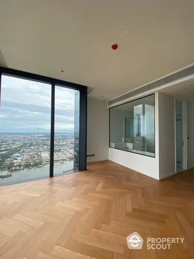 Luxurious high-rise apartment with stunning city view and elegant parquet flooring.