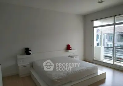 Spacious bedroom with large window and modern minimalist design