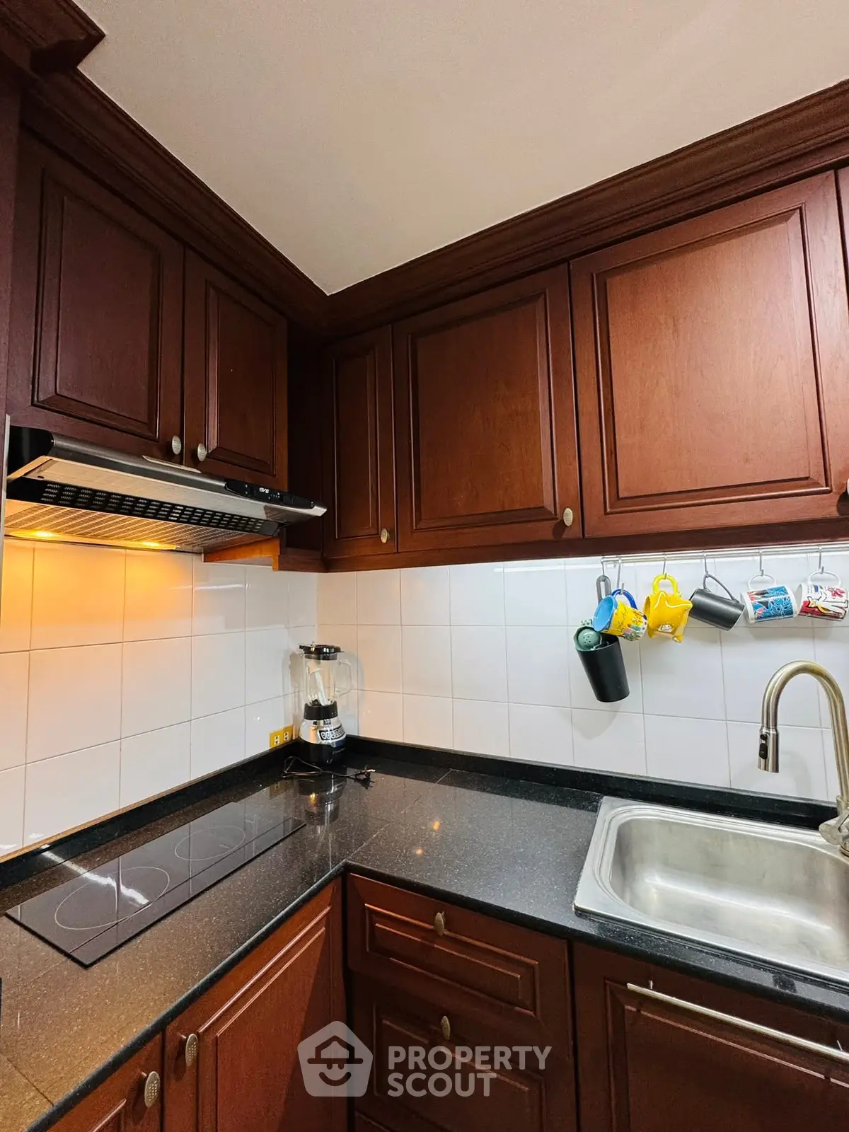 Charming kitchen with dark wood cabinets and modern appliances