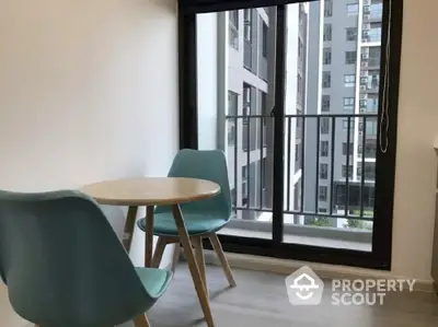 Modern apartment dining area with balcony view and stylish furniture