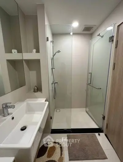 Modern bathroom with glass shower and sleek sink design