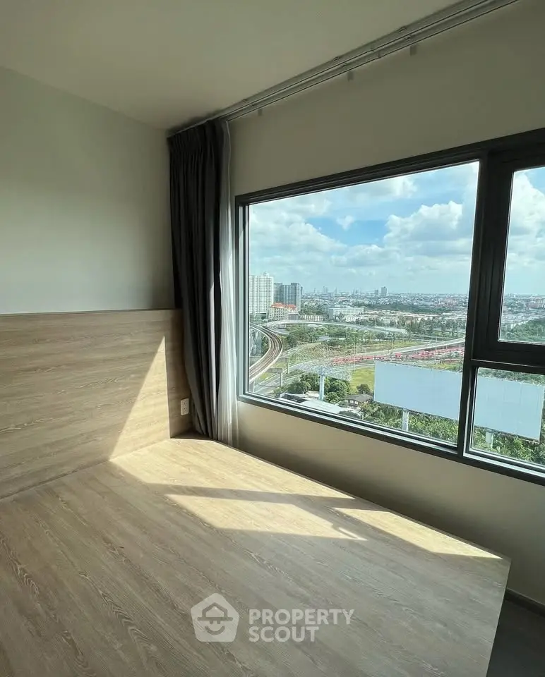 Bright bedroom with large window offering stunning city view