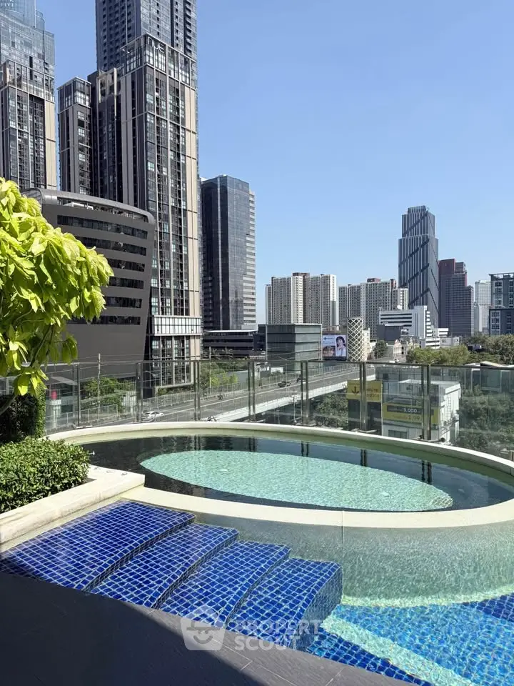 Luxurious rooftop pool with stunning city skyline views in modern urban setting.