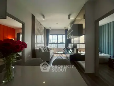 Modern living room with city view, stylish decor, and open layout in a high-rise apartment.