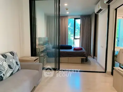 Modern apartment with glass partitioned bedroom and cozy living area