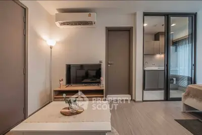 Modern living room with air conditioning and open kitchen layout in stylish apartment.