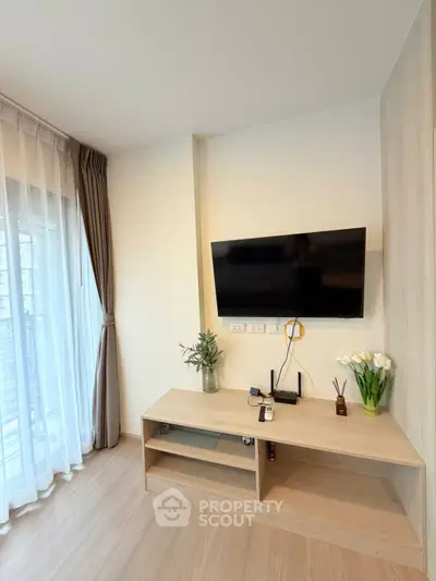 Modern living room with wall-mounted TV and elegant decor
