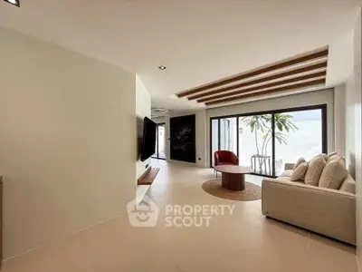 Spacious modern living room with large windows and stylish decor