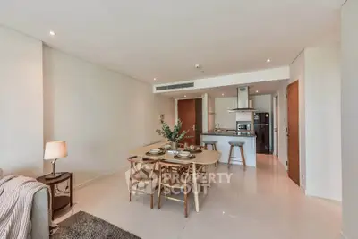 Modern open-plan living and dining area with stylish kitchen in a contemporary apartment.