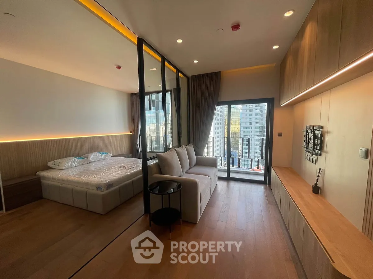 Modern studio apartment with open layout and city view balcony