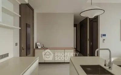 Modern kitchen with sleek design and open layout, featuring a stylish sink and contemporary lighting.
