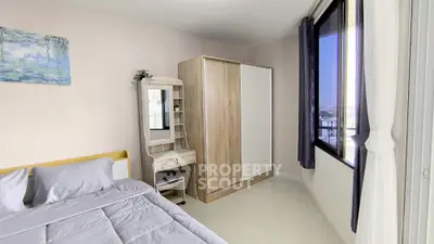 Modern bedroom with stylish wardrobe and large window offering natural light