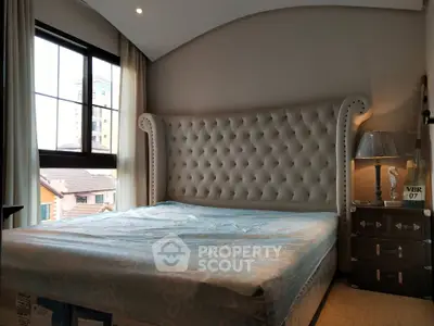 Luxurious bedroom with elegant tufted headboard and city view window