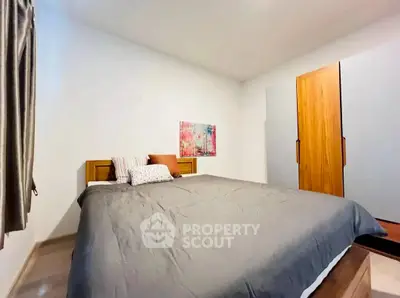 Cozy bedroom with modern decor and ample storage space.