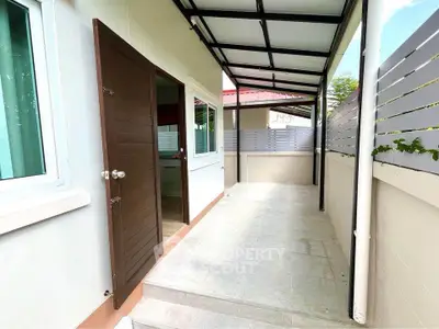 Spacious covered patio with modern design and privacy fencing