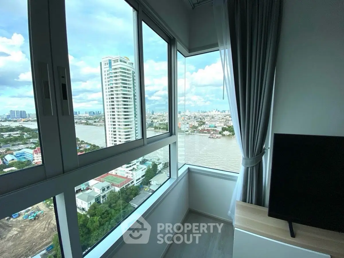 Stunning river view from modern high-rise apartment corner unit.