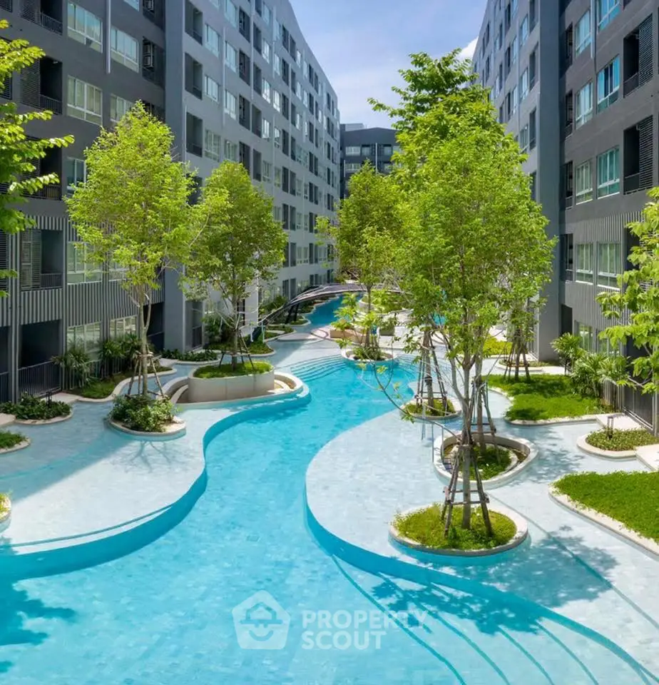 Luxurious apartment complex with stunning pool and lush greenery