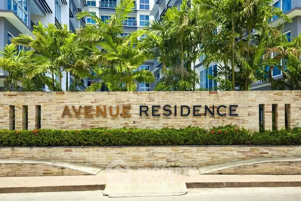 Modern apartment building with lush greenery at Avenue Residence entrance.