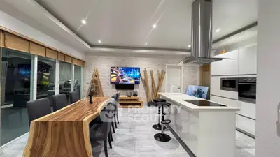 Luxurious modern kitchen with open layout and stylish dining area, featuring sleek appliances and elegant decor.