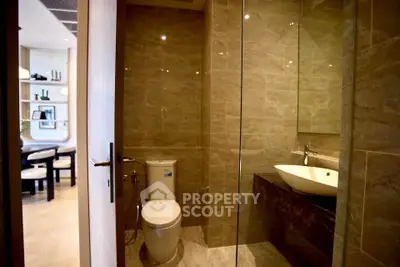 Modern bathroom with glass shower and stylish sink in luxury apartment