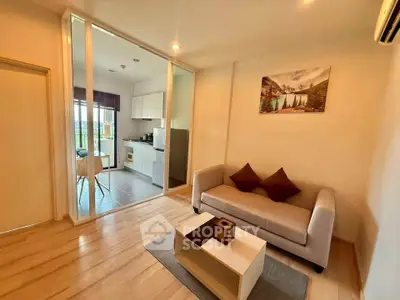 Modern living room with open kitchen and scenic view, featuring cozy sofa and stylish decor.