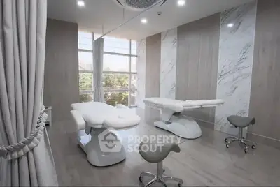 Modern spa treatment room with massage tables and elegant decor