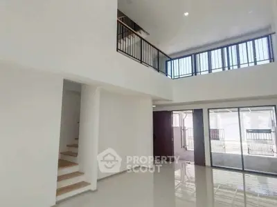 Spacious modern living room with high ceilings and large windows