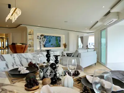Luxurious open-plan living room with elegant decor and modern kitchen, perfect for entertaining.