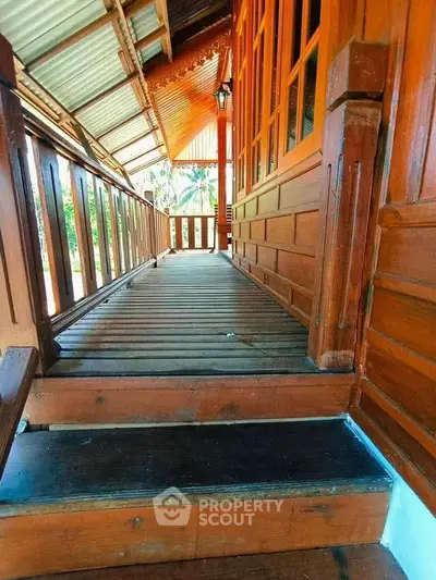 Charming wooden exterior with rustic balcony and lush garden view, perfect for serene living.