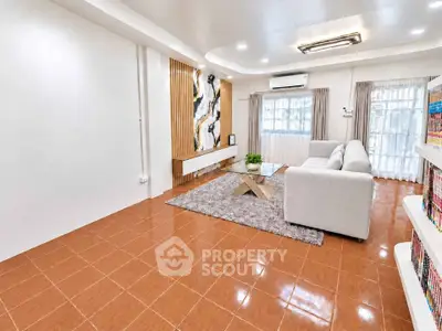 Spacious living room with modern decor and large windows