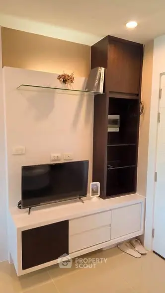 Modern living room corner with sleek TV unit and stylish shelving