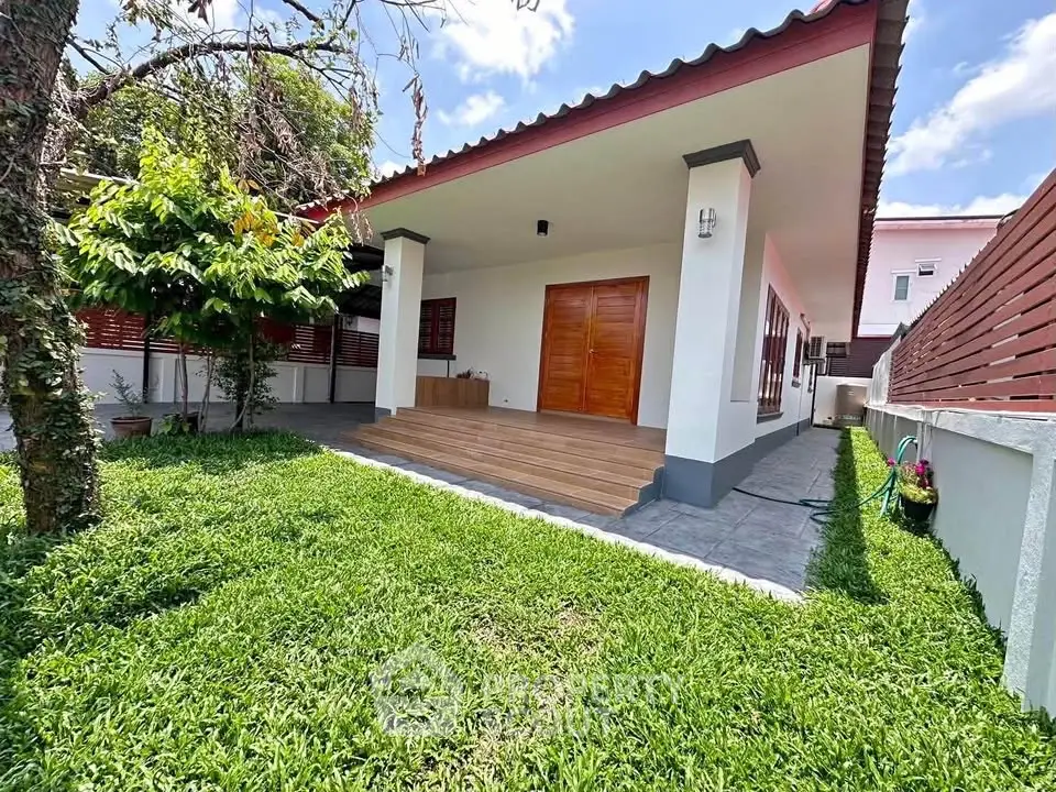Charming single-story home with spacious garden and inviting porch, perfect for outdoor relaxation.