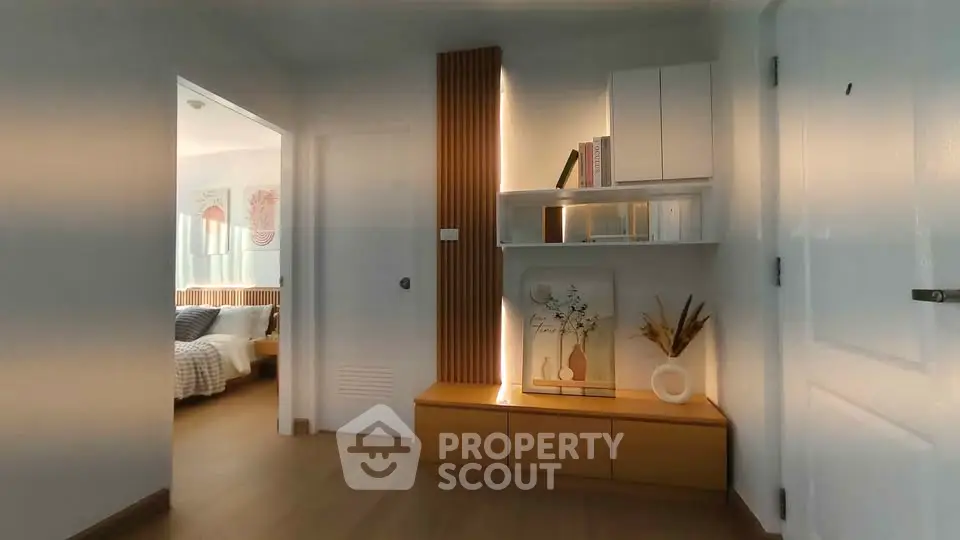 Modern hallway with stylish decor leading to a cozy bedroom