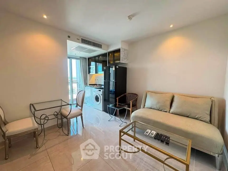 Modern living room with elegant furniture and integrated kitchen appliances in a stylish apartment.