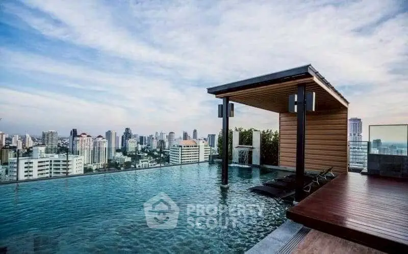 Luxurious rooftop pool with stunning city skyline view, perfect for relaxation and entertainment.