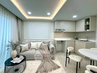 Modern living room with cozy sofa, elegant decor, and sleek kitchen in open layout design.