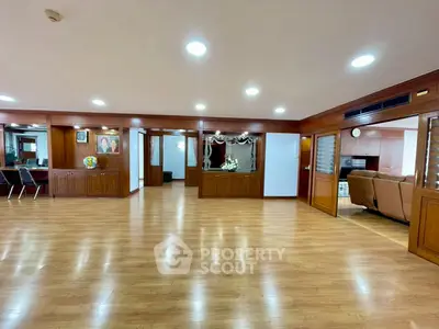 Spacious living room with wooden flooring and elegant decor in a luxurious property.